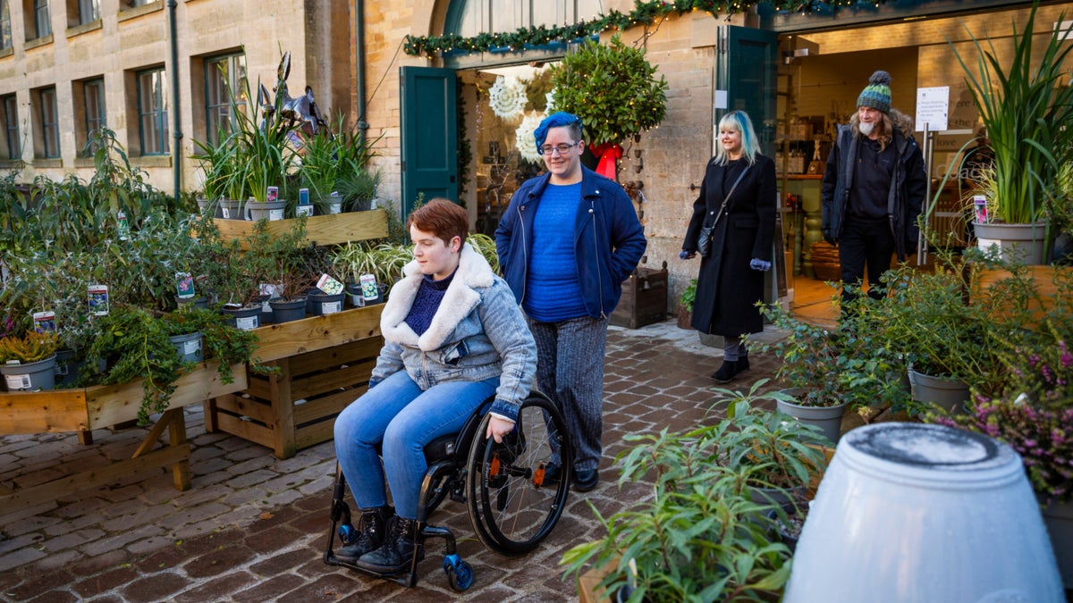 A wheelchair user moving through Belton Estate's improved stable-yard route