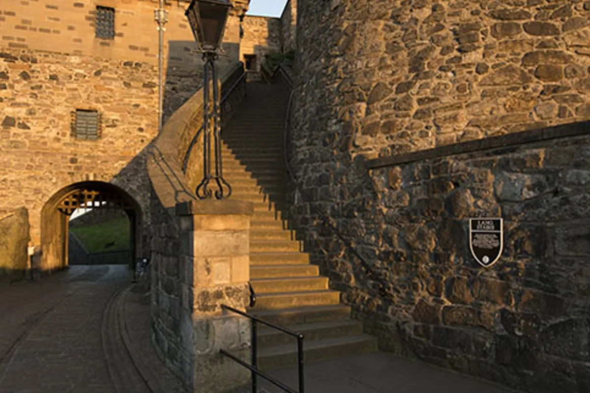 A stepped historic route within Edinburgh Castle beside an arched alternative path