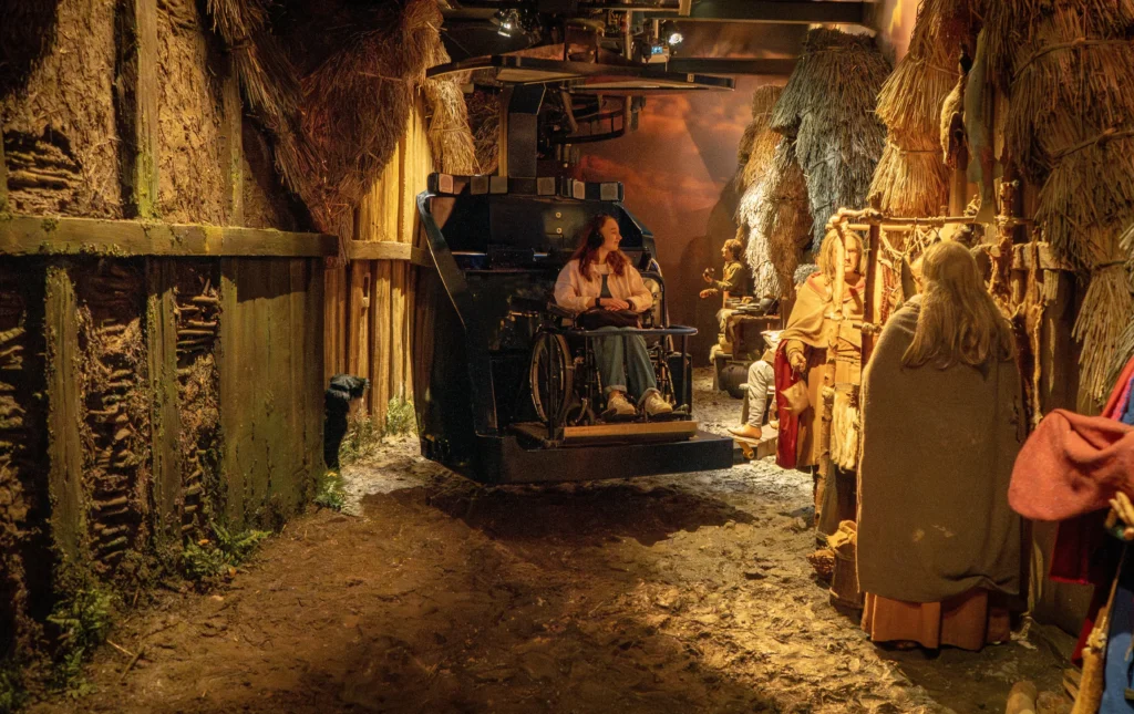 An accessible JORVIK ride capsule travelling through a reconstructed Viking-age street