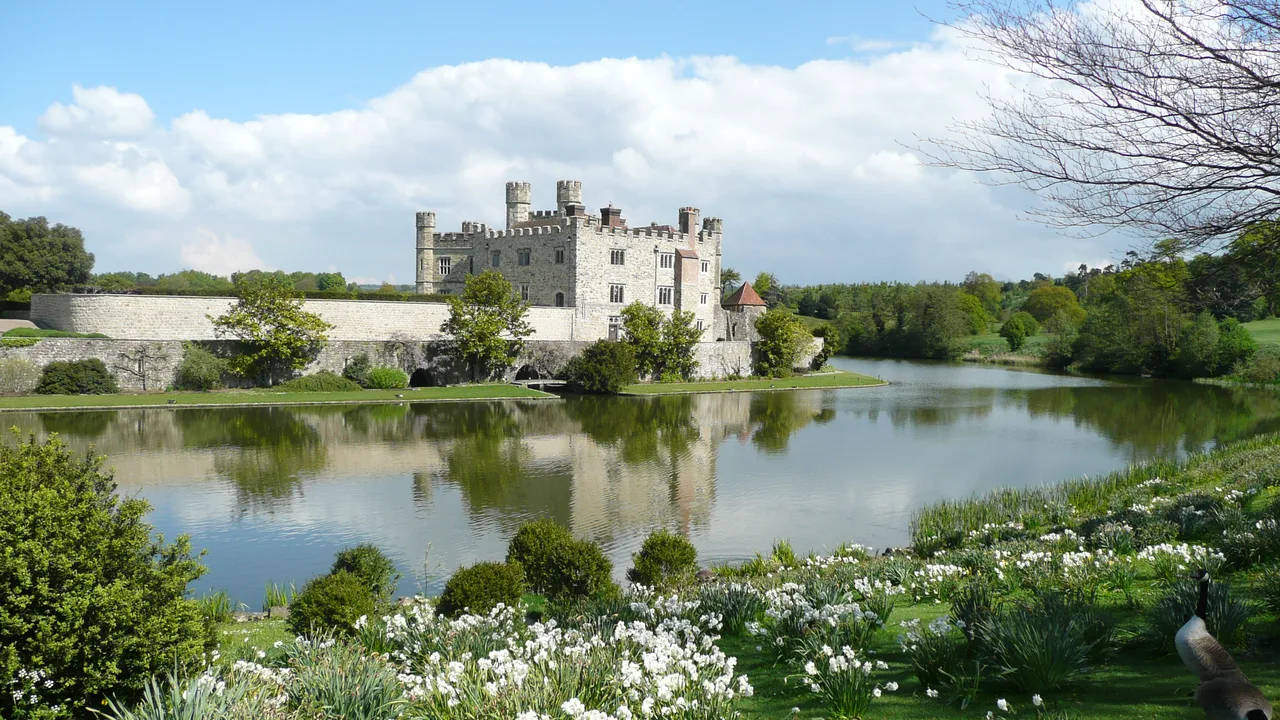 Leeds Castle beside its lake and gardens in Kent
