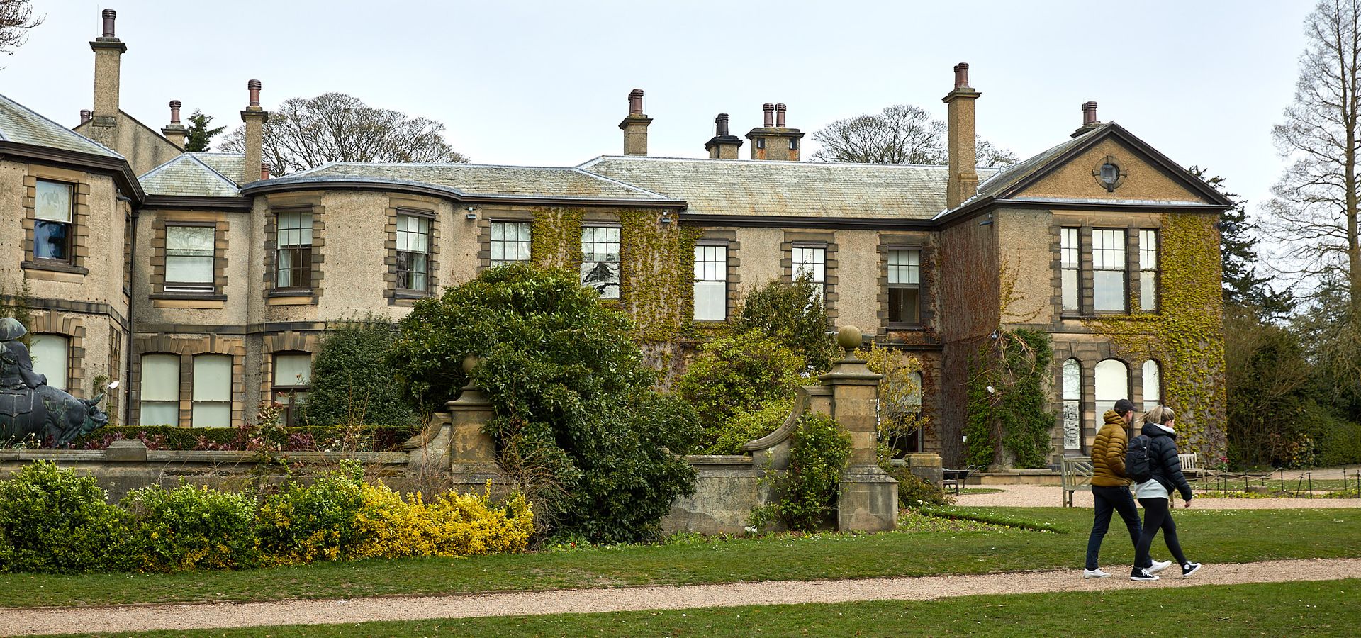 Lotherton Hall viewed from the gardens with a broad gravel path in front