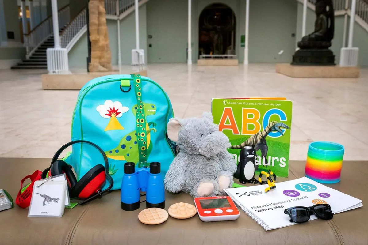 A National Museum of Scotland sensory backpack with ear defenders, tactile objects, sunglasses, binoculars and a sensory map