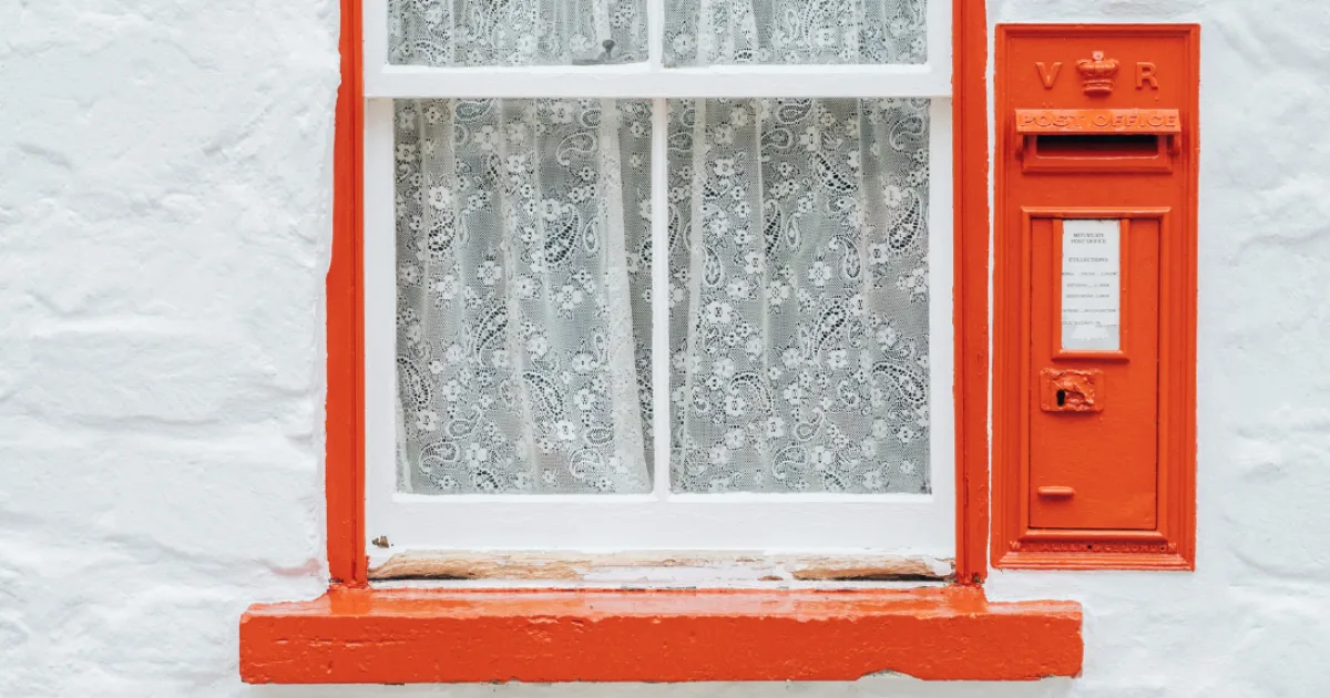 Historic post office window and red post box at Ulster American Folk Park