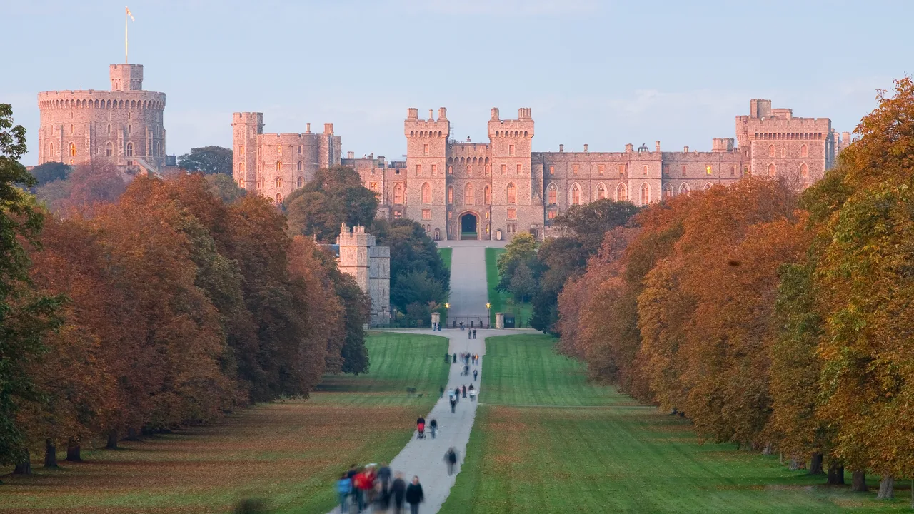 Windsor Castle seen from the Long Walk through autumn trees